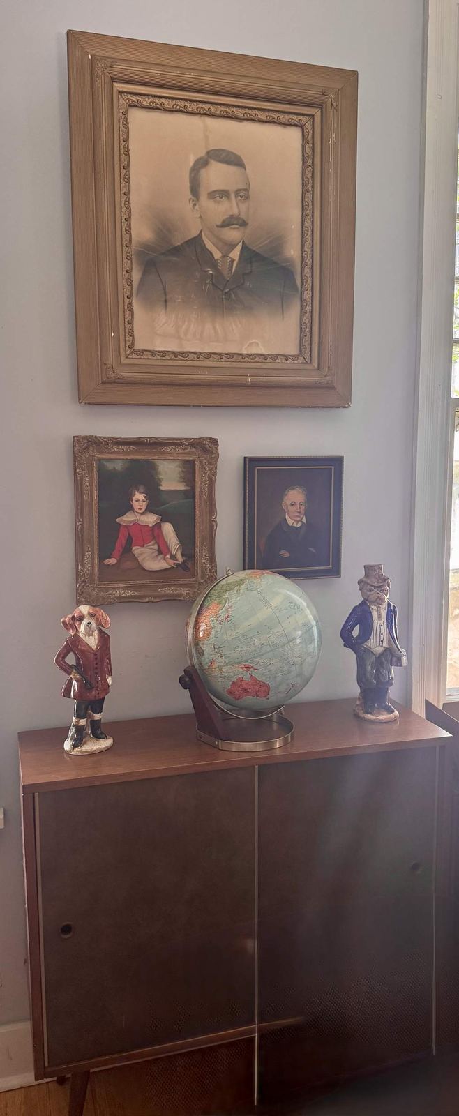 Antique portrait wall with figurines and globe