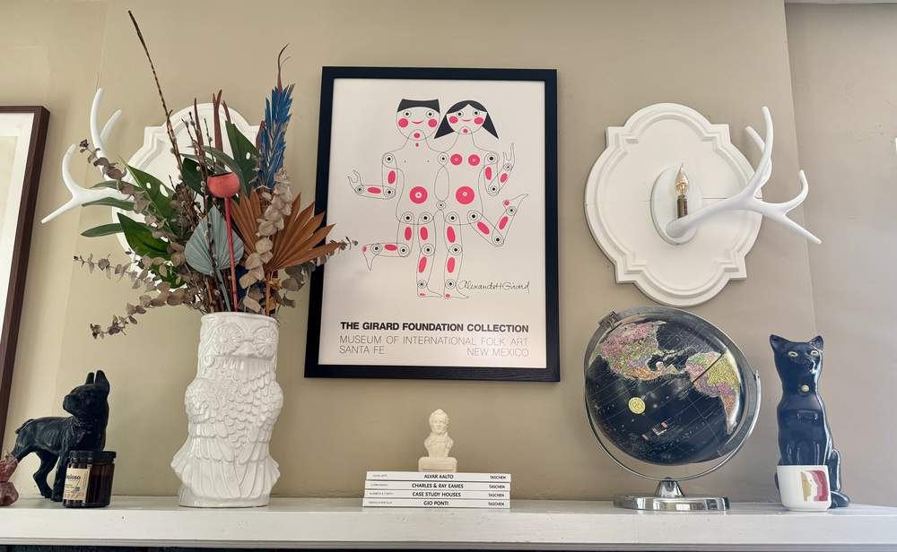 Mantel styled with Girard poster and curios